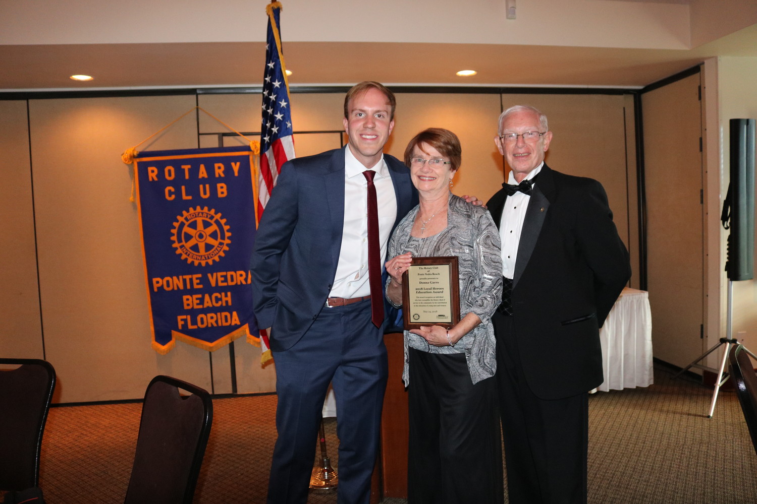 Donna Garro (center) receives the Education Award from Ponte Vedra Recorder Editor Jon Blauvelt (left) and Rotarian Chuck Day (right).